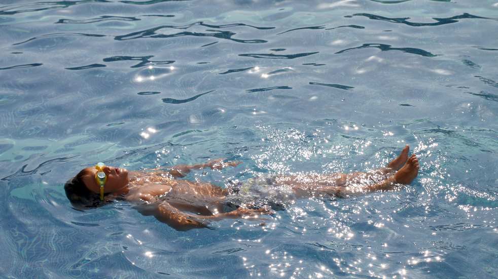 Wild swimming woman on back lido